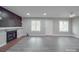 Spacious living room featuring wood accent wall fireplace, grey flooring, and natural light at 1847 J Julian Ln # A, Charlotte, NC 28208