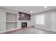 Bright living room showcasing a fireplace with brick accent wall and modern gray flooring at 1847 J Julian Ln # A, Charlotte, NC 28208