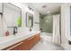 Modern bathroom with a double sink vanity, tiled shower, and large mirror providing ample light at 1847 Vinton St, Charlotte, NC 28216