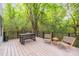Spacious deck with lounge chairs and table surrounded by lush greenery, perfect for outdoor relaxation at 1847 Vinton St, Charlotte, NC 28216
