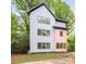 Contemporary home showcasing a modern design with clean lines, large windows, and natural landscaping at 1847 Vinton St, Charlotte, NC 28216