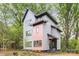 Modern two-story home with gray and pink siding, black trim, and lush green landscaping at 1847 Vinton St, Charlotte, NC 28216