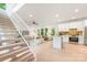 Open-concept living space featuring hardwood floors, a modern kitchen, and a staircase with white railings at 1847 Vinton St, Charlotte, NC 28216