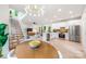 Open concept with modern lighting, kitchen, and dining area featuring hardwood floors and stainless appliances at 1847 Vinton St, Charlotte, NC 28216