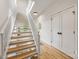 Modern staircase with wooden steps and white railings, leading to a bright upper level with a window at 1847 Vinton St, Charlotte, NC 28216