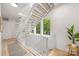 Bright staircase featuring light hardwood stairs and white painted railings at 1847 Vinton St, Charlotte, NC 28216