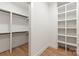 Large walk-in closet with built-in shelving and hanging rods at 1847 Vinton St, Charlotte, NC 28216