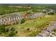 Aerial view of house in golf community, surrounded by green spaces and lakes at 194 Canada Dr, Statesville, NC 28677