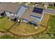 Aerial view of backyard with playground, screened porch, and solar panels on roof at 194 Canada Dr, Statesville, NC 28677