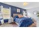 Stylish bedroom featuring dark blue accent wall and a plush bed with patterned rug at 194 Canada Dr, Statesville, NC 28677