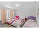 Bright bedroom featuring three beds, rainbow decor and cozy textiles at 194 Canada Dr, Statesville, NC 28677