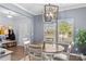 Bright dining area with a modern chandelier, table, and large windows offering neighborhood views at 194 Canada Dr, Statesville, NC 28677
