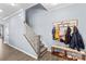 Welcoming entryway with hardwood floors, a coat rack, and a staircase leading to the upper level at 194 Canada Dr, Statesville, NC 28677
