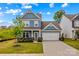 Charming two-story home with a well-manicured lawn and a two-car garage in a Gathering-friendly neighborhood at 194 Canada Dr, Statesville, NC 28677