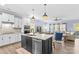 Open concept kitchen with island, stainless steel appliances, and views to the living room at 194 Canada Dr, Statesville, NC 28677