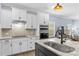 Modern kitchen featuring white cabinets, stainless steel appliances, and granite countertops at 194 Canada Dr, Statesville, NC 28677