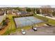 Aerial view of community tennis courts, enclosed with a chain-link fence and a parking lot nearby at 194 Canada Dr, Statesville, NC 28677