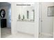 Bright bathroom features double sink vanity with granite countertop and a tiled floor at 201 Giant Oak Ave, Statesville, NC 28677
