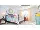 Bright bedroom with a four-poster bed, patterned linens, and a cozy seating area by the window at 201 Giant Oak Ave, Statesville, NC 28677