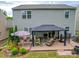 Spacious backyard featuring a covered patio, outdoor seating, and a well-maintained lawn at 2037 Christopher Wood Ct, Indian Land, SC 29707