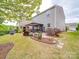 A well-maintained backyard featuring a stone pathway and covered patio, ideal for outdoor gatherings and relaxation at 2037 Christopher Wood Ct, Indian Land, SC 29707