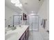 Bathroom features a double sink vanity with modern fixtures, a glass enclosed shower, and white tile floors at 2037 Christopher Wood Ct, Indian Land, SC 29707