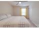 This bedroom features neutral carpet, a ceiling fan, a window with curtains, and a closet at 2037 Christopher Wood Ct, Indian Land, SC 29707