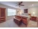 Bedroom is decorated with ceiling fan, area rug, an accent chair, and a large window at 2037 Christopher Wood Ct, Indian Land, SC 29707