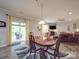 Cozy dining room showcases an elegant wooden table, stylish rug, and sliding glass doors to the deck at 2037 Christopher Wood Ct, Indian Land, SC 29707