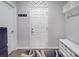 Clean entryway features a white door, coat hooks, and built-in shelving for an organized space at 2037 Christopher Wood Ct, Indian Land, SC 29707