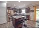 Well-equipped kitchen featuring stainless steel appliances, dark cabinetry, granite countertops and a center island at 2037 Christopher Wood Ct, Indian Land, SC 29707