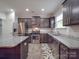 Stylish kitchen with stainless steel appliances, granite countertops, and dark cabinetry at 2037 Christopher Wood Ct, Indian Land, SC 29707