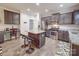 Modern kitchen featuring stainless steel appliances, an island with breakfast bar seating, and dark cabinets at 2037 Christopher Wood Ct, Indian Land, SC 29707
