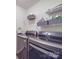 Functional laundry room is equipped with modern washer and dryer units and practical shelving at 2037 Christopher Wood Ct, Indian Land, SC 29707