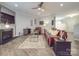 Open-concept living room with a fireplace, comfortable seating, and modern decor at 2037 Christopher Wood Ct, Indian Land, SC 29707