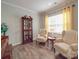 Cozy living room with hardwood floors, a decorative china cabinet, and natural light from large window at 2037 Christopher Wood Ct, Indian Land, SC 29707