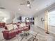 Open-concept living room and kitchen with hardwood floors, stylish furniture, and ample natural light at 2037 Christopher Wood Ct, Indian Land, SC 29707