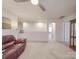 Open loft featuring neutral carpeting, a ceiling fan, and space for relaxing or entertaining at 2037 Christopher Wood Ct, Indian Land, SC 29707