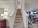 A staircase with wood floors and white walls at 2037 Christopher Wood Ct, Indian Land, SC 29707