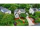 Aerial view of a beautifully landscaped home with a well-manicured lawn, mature trees, and a paved driveway at 21300 Crown Lake Dr, Cornelius, NC 28031
