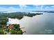 Picturesque aerial view of a waterfront property with lush greenery, a private dock, and stunning lake views at 21300 Crown Lake Dr, Cornelius, NC 28031