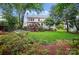 Spacious backyard with a deck, lush greenery, and a well-maintained lawn, perfect for outdoor activities at 21300 Crown Lake Dr, Cornelius, NC 28031