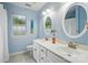 Light blue bathroom features double vanity, tile floors, and a window with a view at 21300 Crown Lake Dr, Cornelius, NC 28031