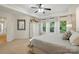 Serene primary bedroom with neutral tones, tray ceilings, large windows, and a view of the outdoors at 21300 Crown Lake Dr, Cornelius, NC 28031