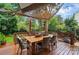 Outdoor deck features a dining table with string lights, creating an inviting space for entertaining at 21300 Crown Lake Dr, Cornelius, NC 28031