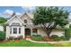 Charming home featuring a stone facade, well-maintained landscaping, and inviting curb appeal at 21300 Crown Lake Dr, Cornelius, NC 28031