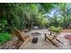 Secluded backyard fire pit area with Adirondack chairs and a swing, ideal for cozy evenings and gatherings at 21300 Crown Lake Dr, Cornelius, NC 28031