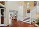 Elegant foyer with hardwood floors, a staircase, and a view into the adjacent dining room at 21300 Crown Lake Dr, Cornelius, NC 28031