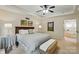Spacious main bedroom featuring a king bed, tray ceiling, soft lighting and an ensuite bathroom at 21300 Crown Lake Dr, Cornelius, NC 28031