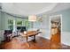Well-lit office with hardwood floors, stylish lighting, and seamless access to other areas at 21300 Crown Lake Dr, Cornelius, NC 28031